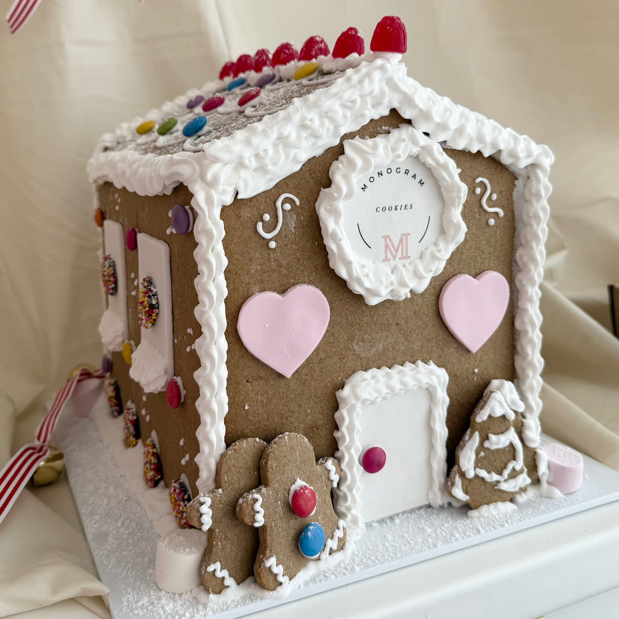 Deluxe hand-decorated gingerbread house with intricate festive detailing, golden-baked gingerbread, and colorful holiday decorations, perfect as a centerpiece or gift