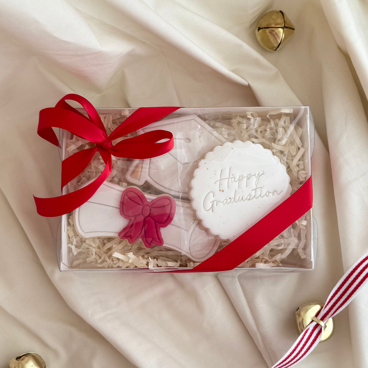 Custom decorated graduation cookies featuring caps, diplomas, and celebratory designs, perfect for gifting graduates.